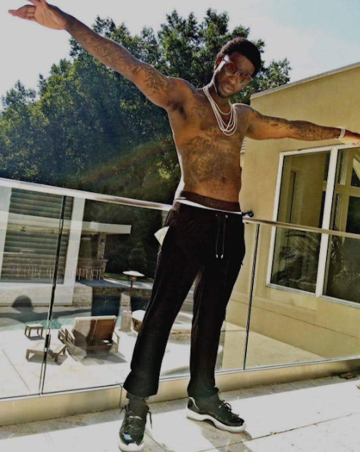 Gucci Mane, who loves 'Game of Thrones' posing topless in black pants and black-white sneakers.