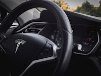A close-up of the inside and the wheel of a Tesla car in one of the only US states you can buy Elon ...