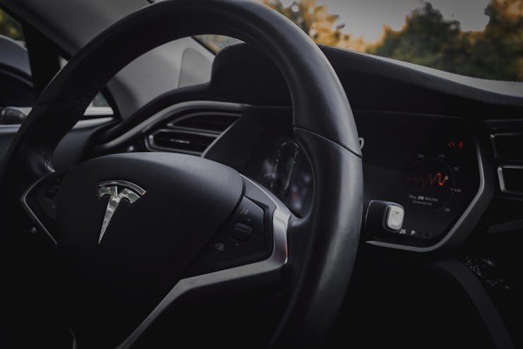 A close-up of the inside and the wheel of a Tesla car in one of the only US states you can buy Elon ...