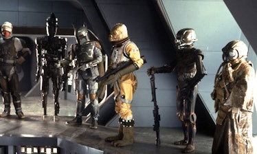 Bossk, the reptile guy, hanging out with other Bounty Hunters in 'The Empire Strikes Back'