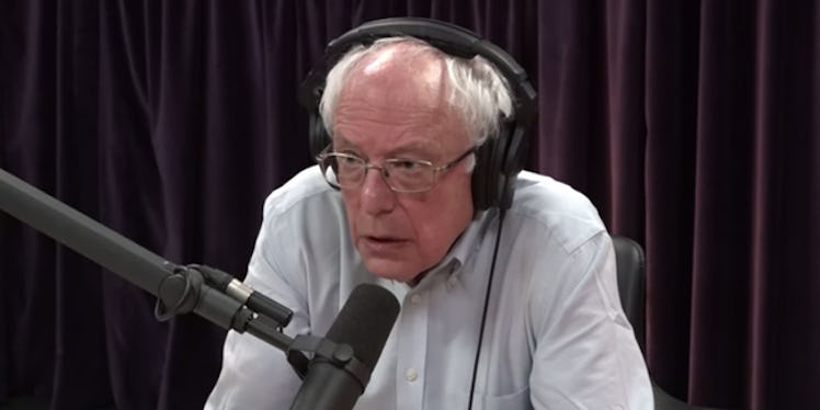 Bernie Sanders talking with headphones on his head
