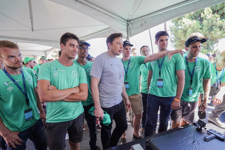 Musk standing with the Delft team.
