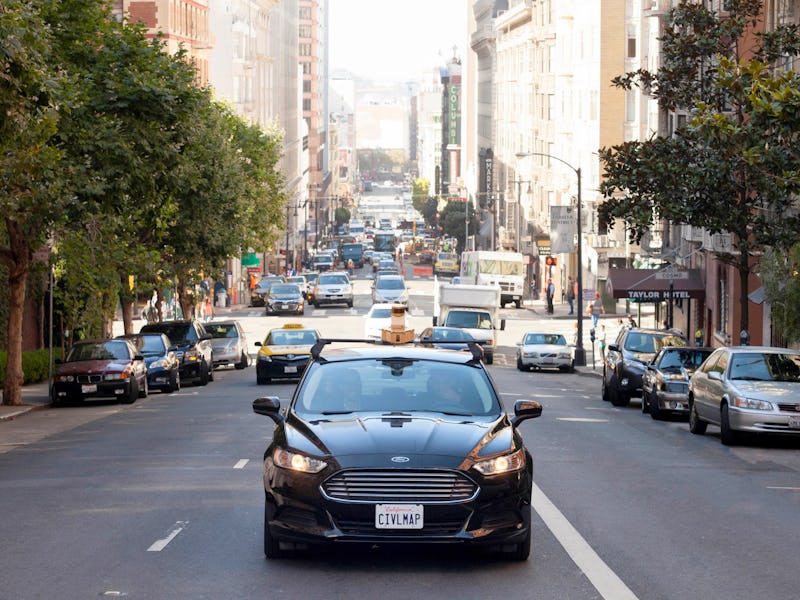 A black Ford car driving through the middle of a busy city during the day