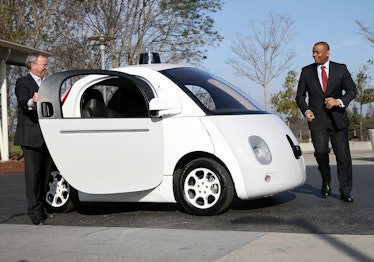 U.S. Transportation Secretary Anthony Foxx and Google Chairman Eric Schmidt (left) get out of a Goog...