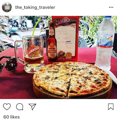A pizza with weed served on a table with a Cambodia beer