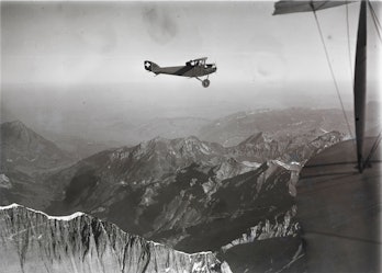 biplane flying over the Alps 