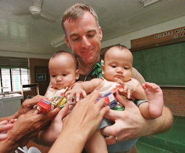 U.S. Marine Dr. Christopher Soltis, of Connecticut, holding twin Filipino baby patients