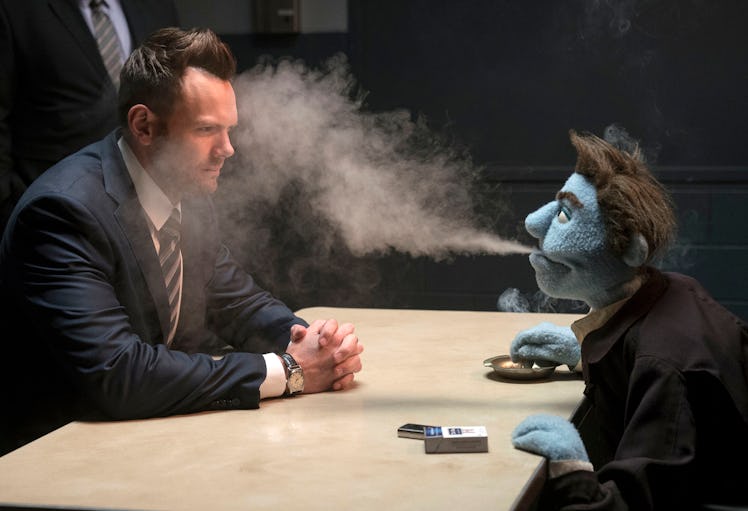 Phil Philips blasts an impossible amount of cigarette smoke into the face of Joel McHale's FBI agent...
