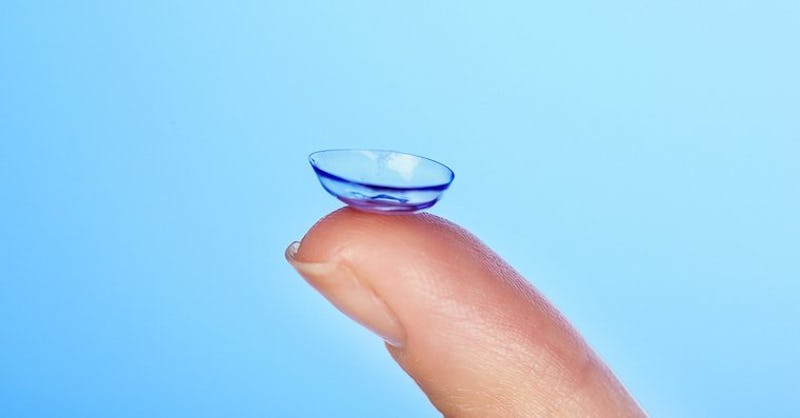 A finger holding a contact lense 
