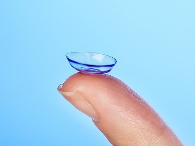 A finger holding a contact lense