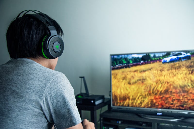 A person playing a video game in the Razer Thresher Ultimate gaming headset