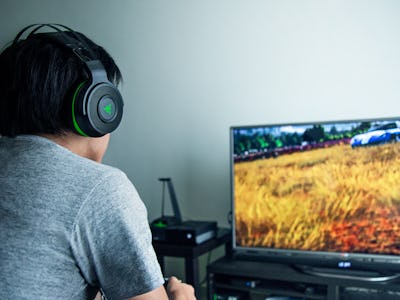 A person playing a video game in the Razer Thresher Ultimate gaming headset