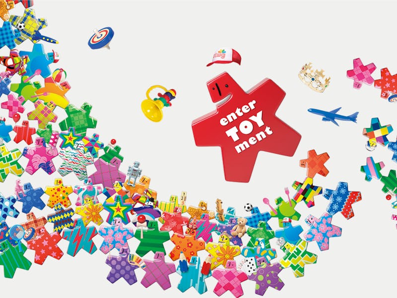 A promotional poster for the Tokyo Toy Show with various multi-colored puzzle-like elements.