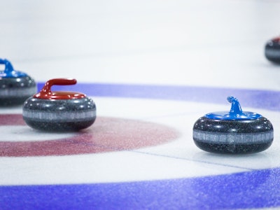 Four curling stones on Ice for the Curling sport