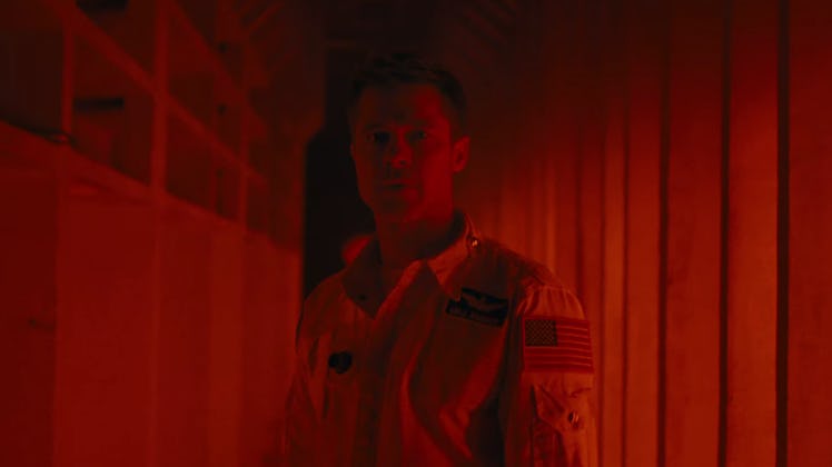 Brad Pitt as Roy McBride in a red hallway in 'Ad Astra'