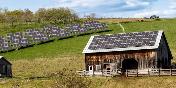 A farm house with solar panels on it