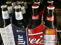 Two 6-packs of beers representing the Anheuser-Busch Inbev-Sabmiller merger