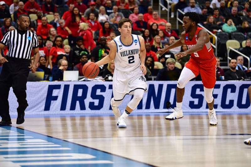 Villanova basketball player playing a game on the court while wearing a white jersey