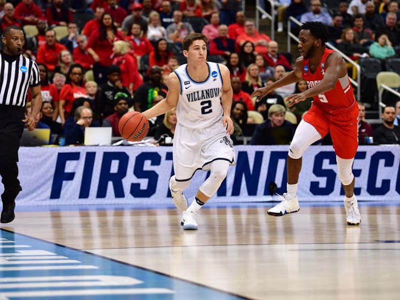 Villanova basketball player playing a game on the court while wearing a white jersey