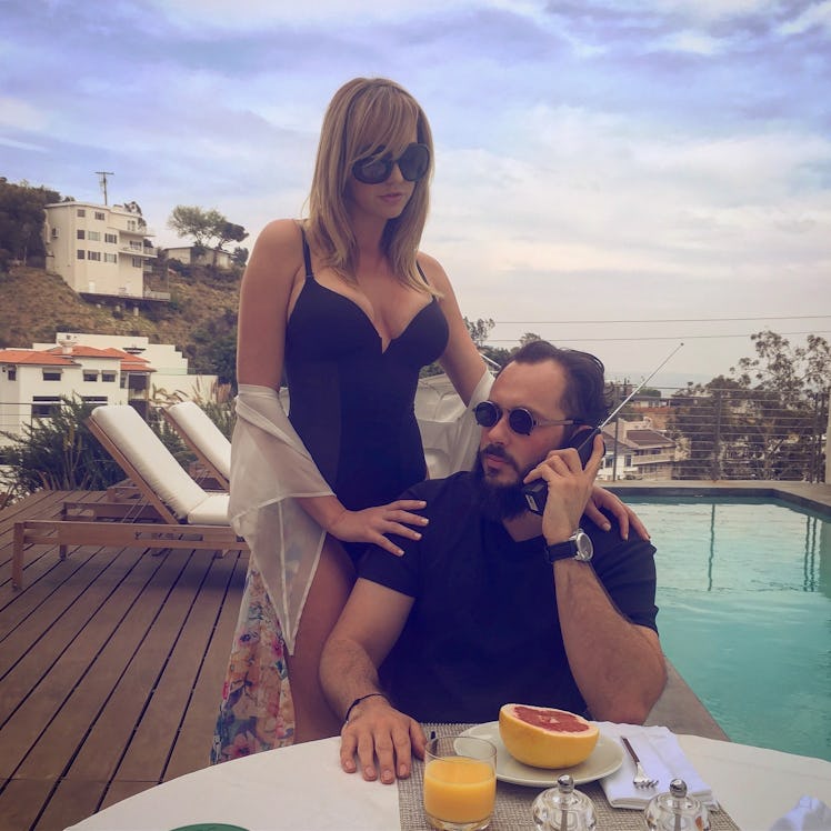 Greg Lansky posing for a photo with a blonde female model