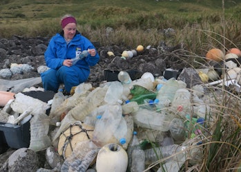 Study co-author Maelle Connan inspects bottles to see where they came from.