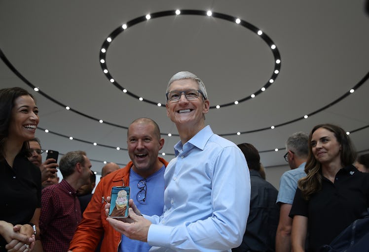 Apple CEO Tim Cook (R) and Apple chief design officer Jonathan Ive (L) look at the new Apple iPhone ...