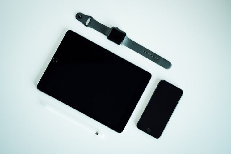 iPhone, iPad, and an Apple watch on a white background