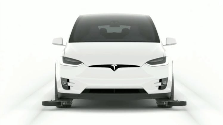 A Tesla Model X with guide wheels.