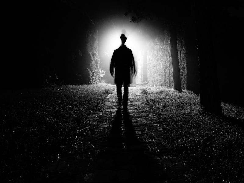 A man walking down a dark street