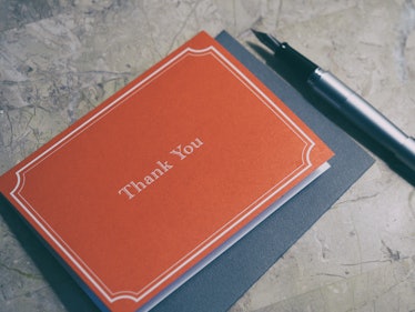 Red paper note block with a "thank you" message