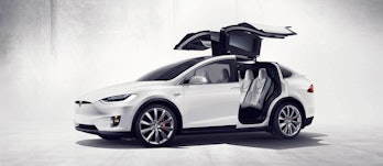 The Tesla Model X with its falcon wing doors open.