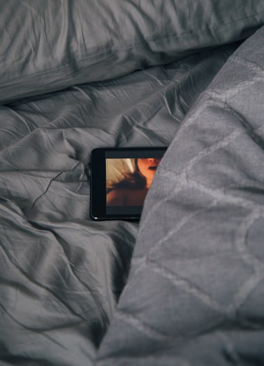porn on a tablet in a bed