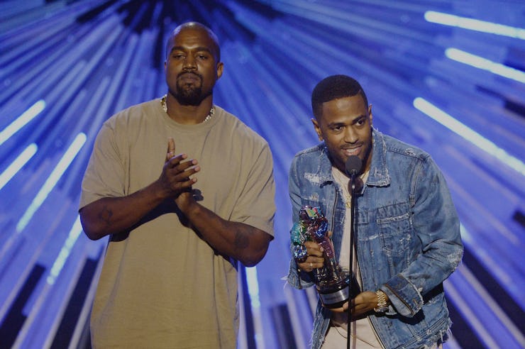 Kanye West in a beige shirt and Big Sean in a white shirt and blue denim jacket on stage during an a...