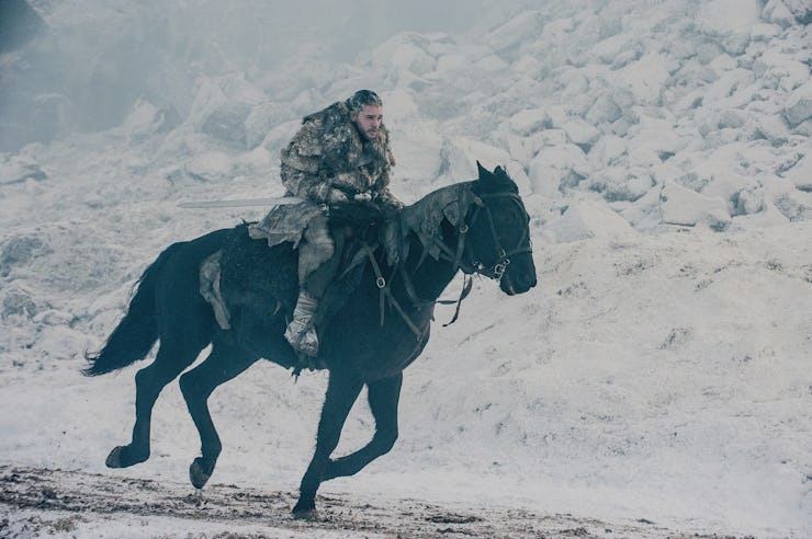 Jon Snow riding a horse through a snow storm in Game of Thrones