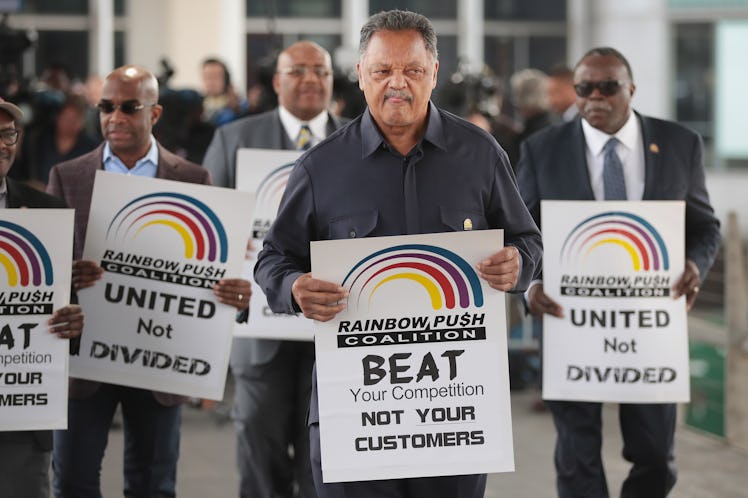 Civil rights leader Reverend Jesse Jackson leads a small group from the Rainbow PUSH Coalition in a ...