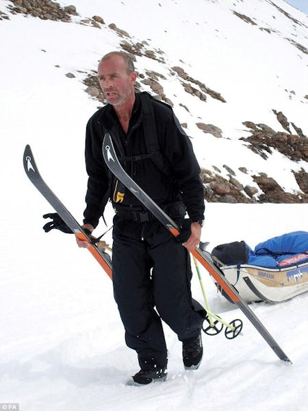 Explorer Henry Worsley on a mountain site, carrying ski equipment