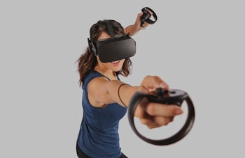 A brunette woman smiling and using the Oculus Rift + Touch Virtual Reality System