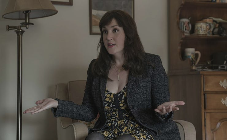Molly Strand from 'Castle Rock' sitting in a room and talking to someone.