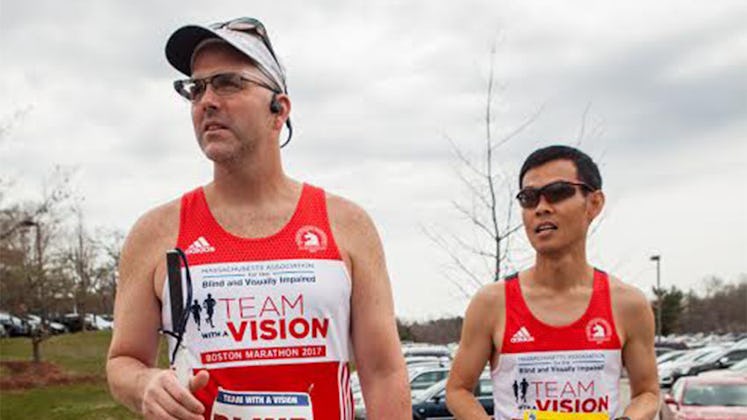 Two guys in a running outfits and rocking cool wearable tech ready for a marathon