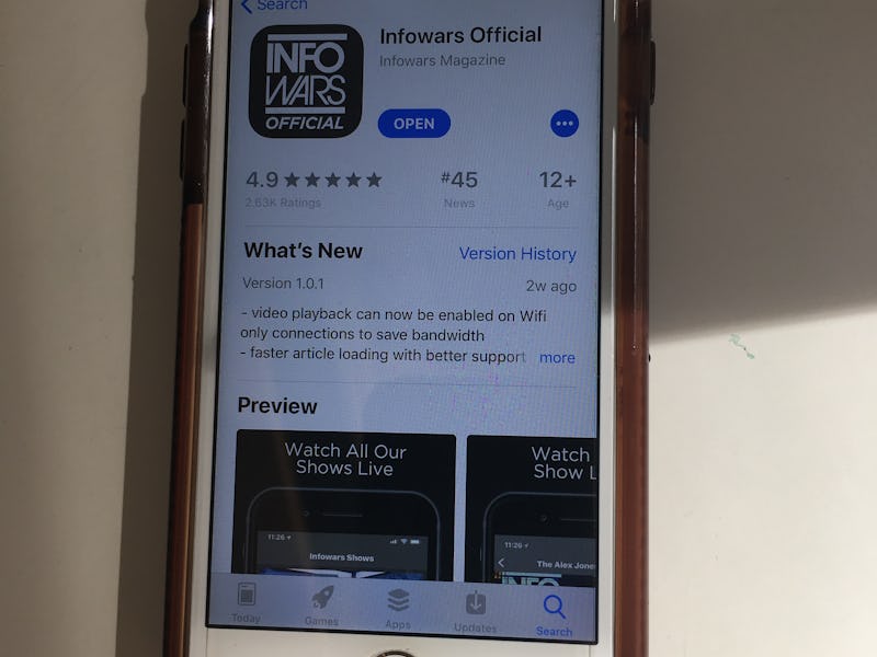 An iPhone with the App Store opened on the "Infowars Official" app 