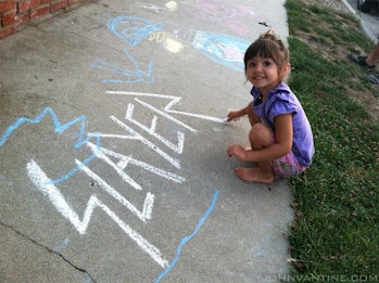 A little girl helps finish off the 'R' in the Slayer logo.