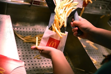 MIAMI, FL - APRIL 25: McDonald's crew member Samantha Medina prepares french fries as the McDonald's...
