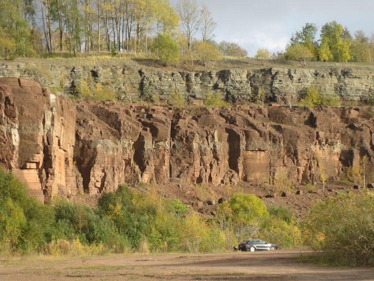 Researchers identified a clear line in sedimentary rock formations where matter from a broken-up ast...