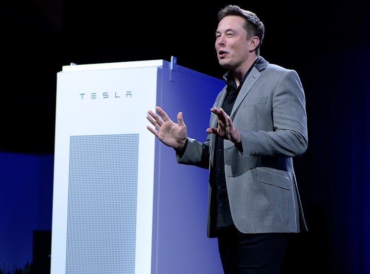 Elon Musk, CEO of Tesla, standing next to a Powerpack unit