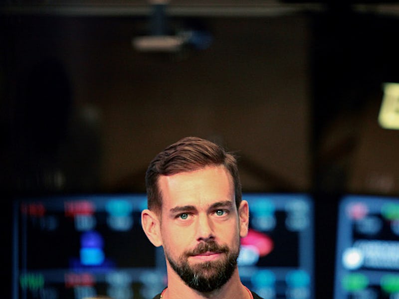 A closeup of Jack Dorsey with screens behind him