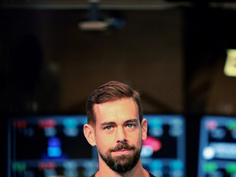 A closeup of Jack Dorsey with screens behind him 