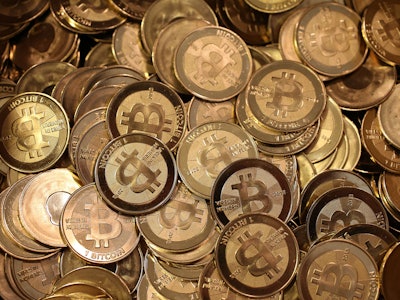 A large pile of physical Bitcoin coins