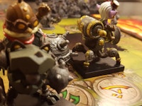 Mechs vs. Minions figures placed on a board