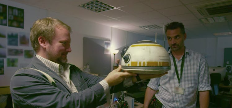 Director Rian Johnson inspects BB-8's head.