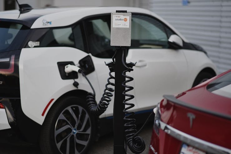 A black and white Tesla car parked while charging